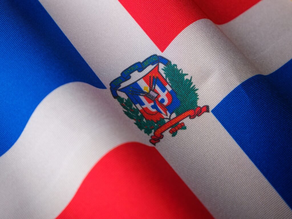 Close-up of the Dominican Republic flag featuring its emblem, symbolizing national pride.